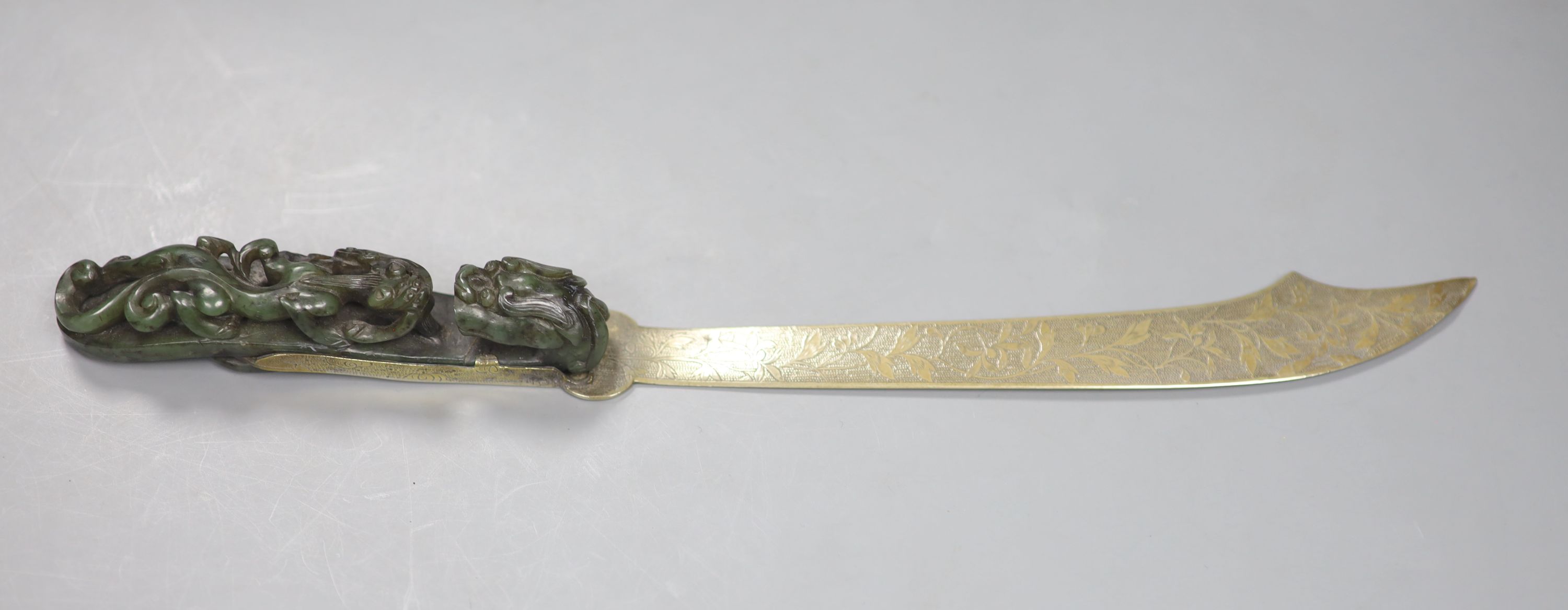 An 18th/19th century Chinese spinach green jadeite dragon belt hook, mounted as the handle for a paperknife, length 32cm